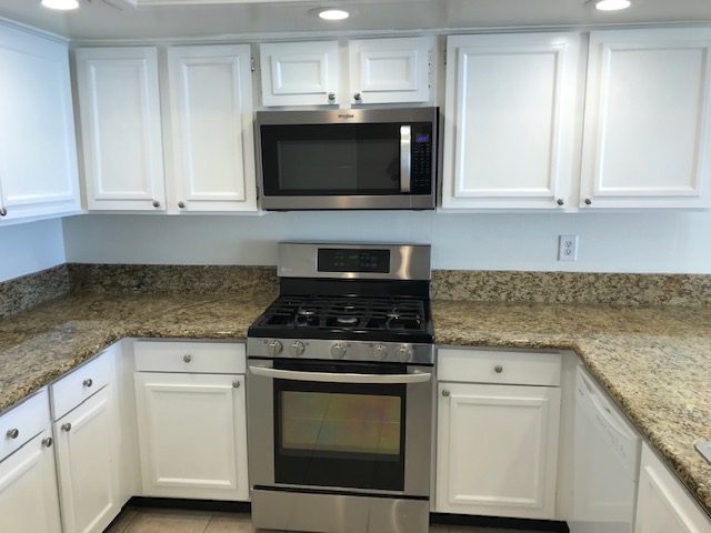 IMG_4309 kitchen with stainless steel stove and microwave